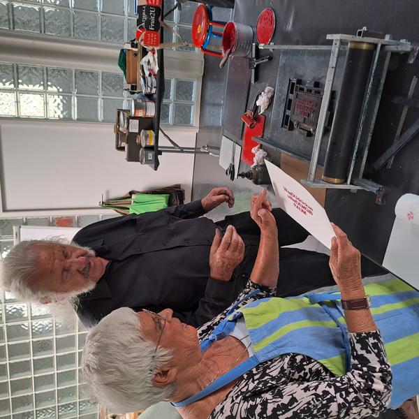 Teilnehmerin Georgia Herold und Kursleiter Ingo Cesaro begutachten einen Handabzug im Workshop „Typografisches Gestalten“